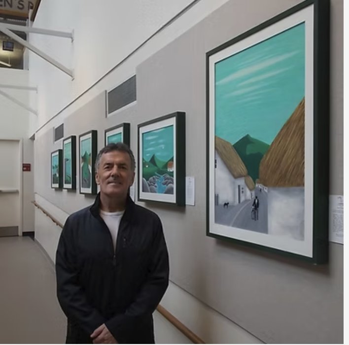The artist standing beside the Connemara painting at a New York exhibition