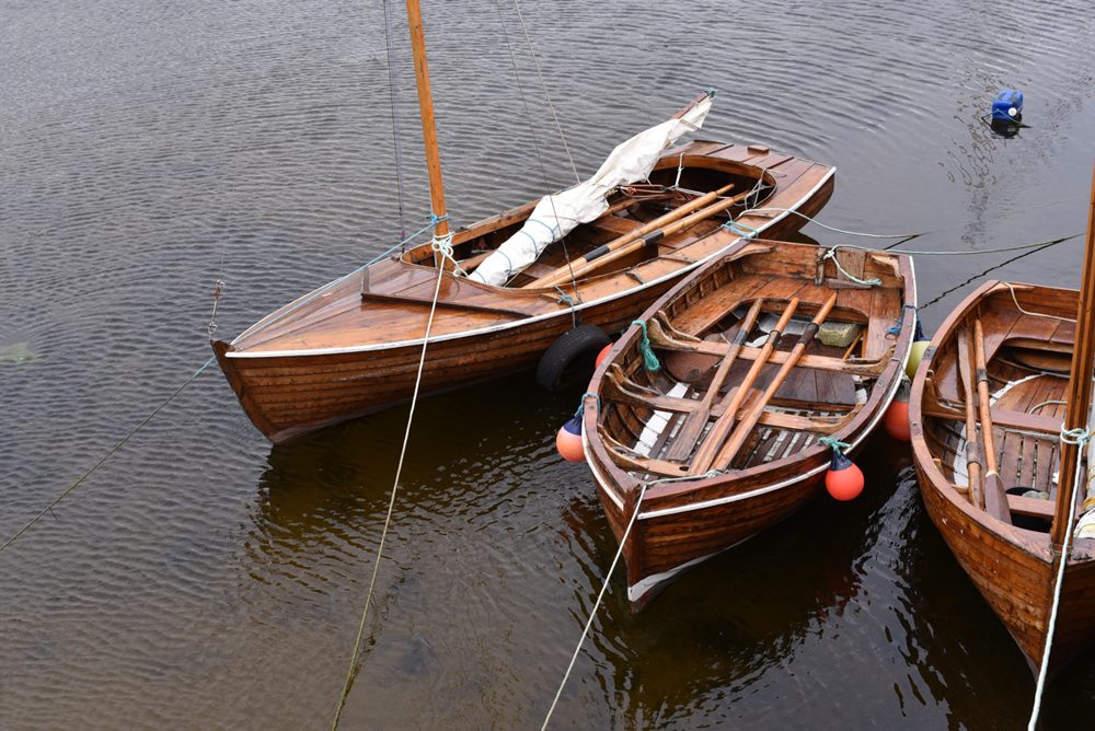 Wooden Boats, Irish photography print: moored wooden rowing boats on dark water, Ireland, by Dan O'Sullivan